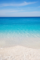 Wall Mural - Shades of Mediterranean blue lapping white pebbles of the Greek Island beach of Myrtos, in Kefalonia, Greece