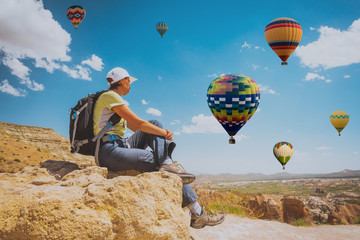 Wall Mural - successful sporty woman in Cappadocia with hot air balloons Concept of motion motivation inspiration