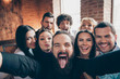 Self-portrait of nice-looking attractive positive crazy cheerful cheery glad people company meeting having fun grimacing at modern industrial brick wood loft style interior house indoors