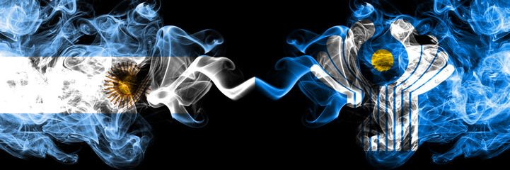 Argentina vs Commonwealth smoky mystic fire flags placed side by side. Thick colored silky abstract smoke flags concept