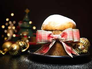 Wall Mural - Panettone for Christmas. Traditional food decorated with bow and golden balls for Xmas. Selective focus.