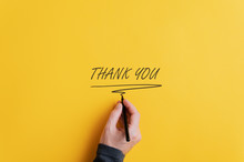 Male Hand Writing A Thank You Sign