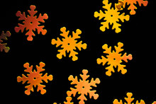Orange Snowflakes On A Black Background. Christmas Background