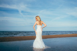 Fototapeta Na drzwi - Portrait of young blond bride staying among the water