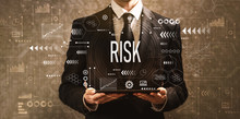 Risk With Businessman Holding A Tablet Computer On A Dark Vintage Background