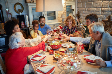 Wall Mural - Family having Christmas dinner at home with happy friends