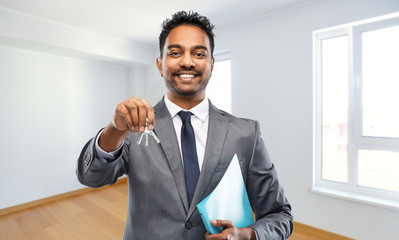 Poster - real estate business and people concept - indian man realtor with keys and folder over empty new apartment room background