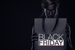 © Mike Orlov - Black friday sale concept for shop. Shopping woman with bodyart and face art holding bag isolated on dark background in holiday.