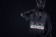 © Mike Orlov - Black friday sale concept for shop. Shopping woman with bodyart and face art holding bag isolated on dark background in holiday.