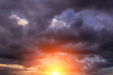 Epic Dramatic Sunset, Sunrise On Storm Sky With Dark Clouds, Orange Yellow Sun And Sunlight