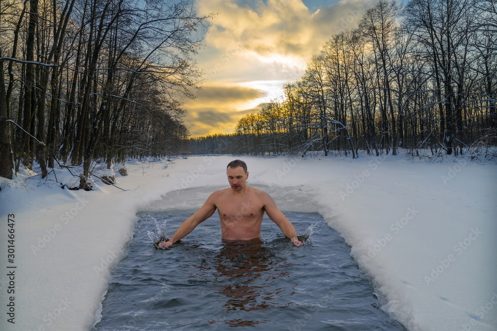 Winter swimming in cold water. Ice hole in the forest, extreme hardening of the body - obrazy, fototapety, plakaty 