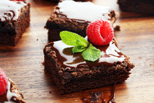 Chocolate Brownie Cake Dessert With Raspberries And Spices On A Wooden Background.