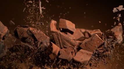 Poster - Super slow motion of flying group of raw chocolate pieces. Filmed on high speed cinema camera, 1000fps.