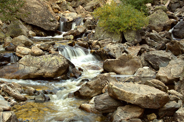 Closeup of water streaming its way thr the large granitre mountain boulders