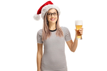 Poster - Young woman with a Santa Claus hat holding a glass of beer