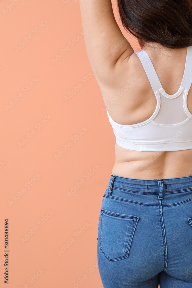 Young body positive woman on color background