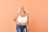 Fototapeta Panele - Portrait of mature body positive woman on color background