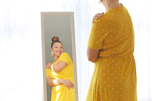 Young Body Positive Woman Looking In Mirror At Home
