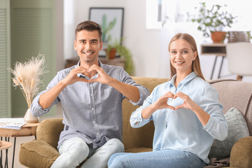 Sticker - Young deaf mute couple using sign language at home