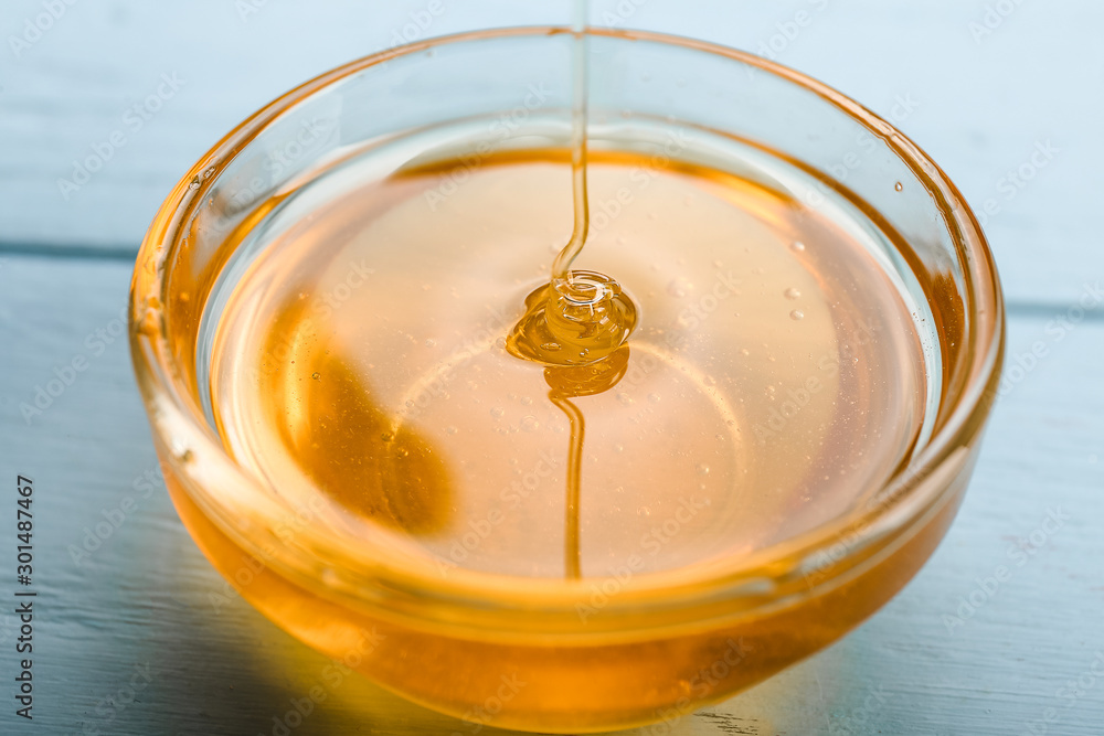 Bowl with honey on table, closeup