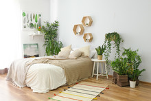 Stylish Interior Of Bedroom With Green Houseplants