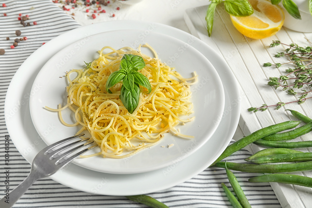 Plates with tasty pasta on table