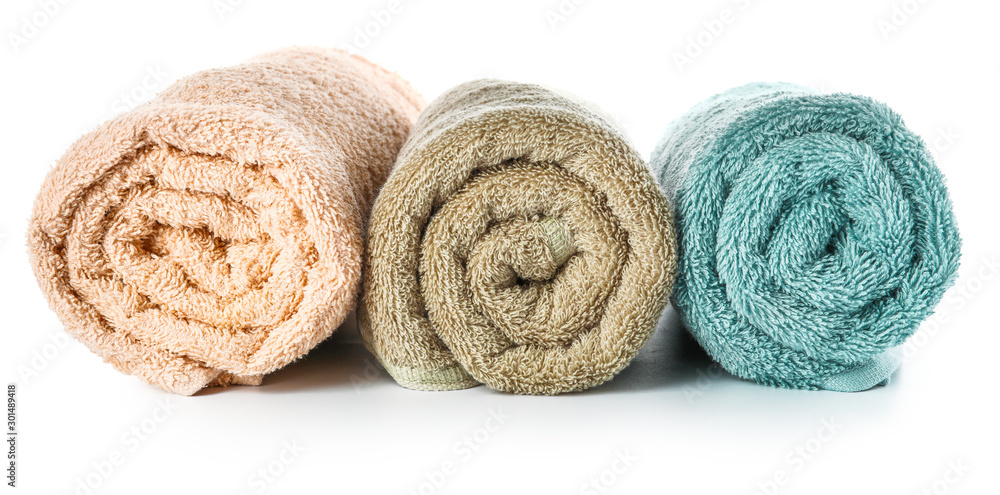 Rolled clean towels on white background