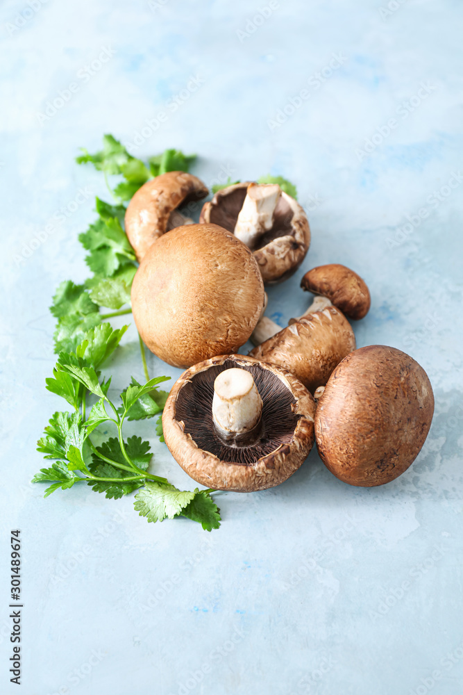 Fresh champignon mushrooms and parsley on color background
