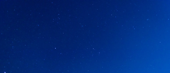 Panorama blue night sky milky way and star on dark background.Universe filled with stars, nebula and galaxy with noise and grain.Photo by long exposure and select white balance