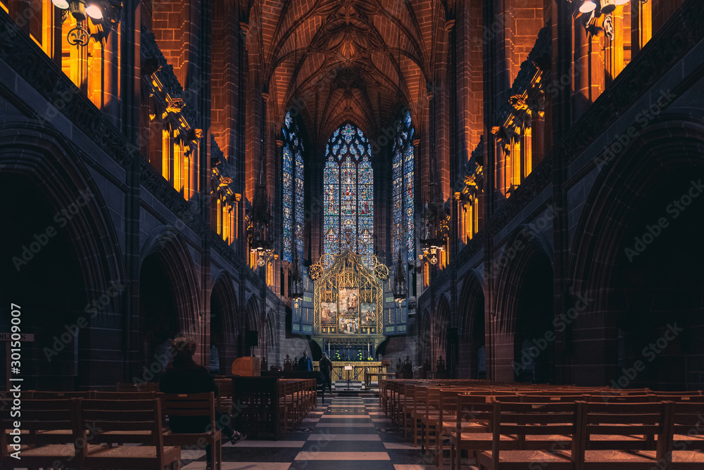 LIVERPOOL, ENGLAND, DECEMBER 27, 2018: The Lady Chapel in Liverpool Anglican Cathedral. Perspective view of a magnificent part inside the church, where light meets darkness all along place. - obrazy, fototapety, plakaty 