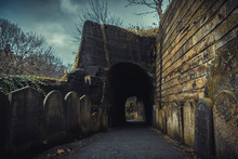 LIVERPOOL, ENGLAND, DECEMBER 27, 2018: Entrance To The Creepy Dark Tunnel To The St James's Cemetery Beside Liverpool Cathedral, With Walls Shaped By Old Moldy Gravestones