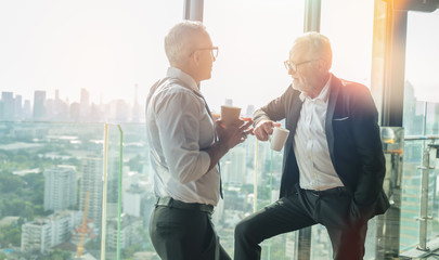 Meeting and discussion concept.business people communicating in office.Mature businessman discuss information with a colleague in a modern business lounge high up in an office tower.