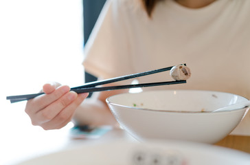  woman eating asian food Beef and meat ball noodle soup