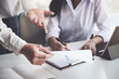 © Jirapong - A male business consultant describes a marketing plan to set business strategies for women business owners witch using tablet. business planning and researching concept.