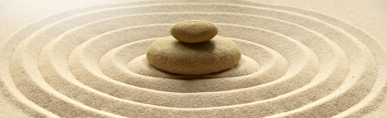 zen garden meditation stone background with stones and lines in sand for relaxation balance and harm