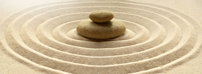 zen garden meditation stone background with stones and lines in sand for relaxation balance and harm