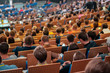 © Anton Gvozdikov - Business conference attendees sit and listen