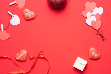 Wall Mural - Valentine's day red background with heart shape decorations, gift and ribbons. View from above. Flat lay composition