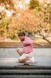 © fesenko - Boy standing on the one knee on the balance board on the concrete steps in the park