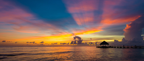 Wall Mural - sun sea tropical sunset view of the pier of the caribbean