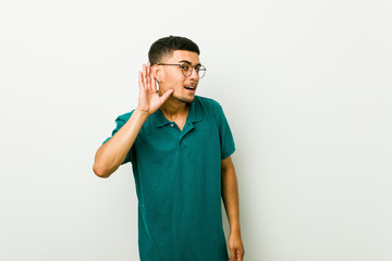 Wall Mural - Young hispanic man trying to listening a gossip.