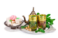 Moroccan Tea With Green Mint And Dessert With The Mint Leaves Isolated On A White Background