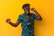 © Asier - Young black rasta man wearing a vacation look dancing and having fun.