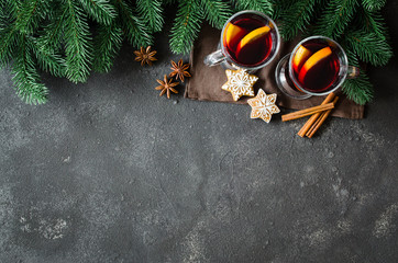 Christmas mulled red wine with spices on dark concrete background