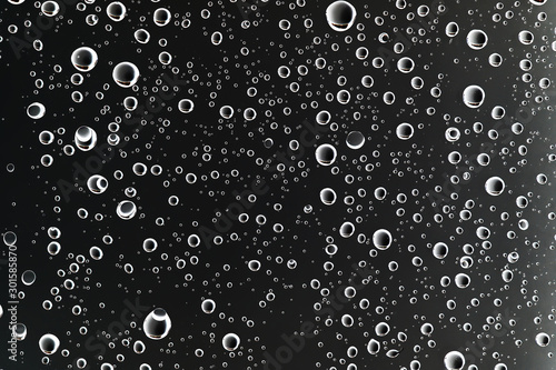 Fotomural black wet background / raindrops for overlaying on window, concept of autumn wea