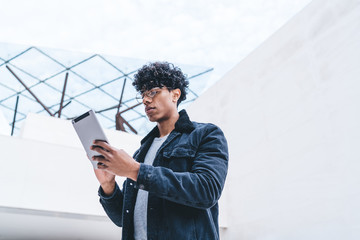 millennial hipster guy in optical spectacles for vision correction typing content text for sharing p