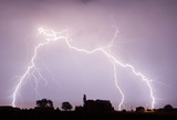 Fototapeta Tęcza - Lightning is a naturally occurring electrostatic discharge during which two electrically charged regions in the atmosphere or ground temporarily equalize themselves.