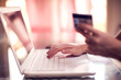© Aleksej - Woman holds credit card and does online payment with laptop. Online shopping concept