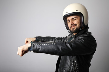 Portrait of biker with white helmet pretending ride his bike. Isolated.