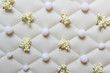 © dariaren - Winter Christmas decorative pattern made of synthetic plant branches with white berries and white fluffy balls arranged on white luxury fabric tufting cloth.